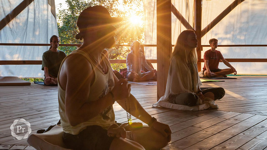 Man chanting Om mantra at sunset