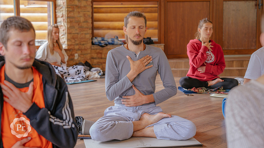 group pranayama in Siddhasana pose